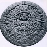 Der „Kalenderstein der Azteken“ aus Basalt mit einem Gewicht von etwa 24 Tonnen. Im Zentrum die Sonne, umgeben von den Glyphen der vier vorhergegangenen Sonnen-Zeitalter: „Windsonne“, „Feuersonne“ „Regensonne“, „Wassersonne“. Um diese Symbole bildet sich ein Kreis mit den 20 Tageszeichen des mexikani sehen Kalenders. Ornamental angeordnet, folgt ein weiterer Kreis von stilisierten Sonnenstrahlen-Zeichen, di« die Jahre anzeigen. Eingerahmt wird die Darstellung von zwei Feuerschlangen (Xiuhcoatl), Symbole der Zei und des Raums. Zwischen den Schlangenleibern findet sich das Kalenderzeichen 13 Rohr, das unserem Jahi 1479 entspricht und vermutlich das Weihedatum dieses gewaltigen Monuments anzeigt. Gefunden wurde diesei Stein auf dem Hauptplatz von Mexiko-Stadt. Das Rohmaterial dafür ist vom Festland herbeigeschafft worden Nach der Eroberung stürzten die Spanier die alten Idole in die Kanäle. Schlamm und Schmutz verbarg sie für Jahrhunderte. Erst mit der Modernisierung des alten Stadtkerns kamen einige Monumente wieder ans Tages¬licht. Unzähliges aber liegt noch unter der modernen 5,5-Millionen-Stadt begraben. Nachklassische Zeit, Aztekische Kultur. 1479? Durchmesser: 360 cm. Museo Nacional de Antropologia, Mexiko D.F.